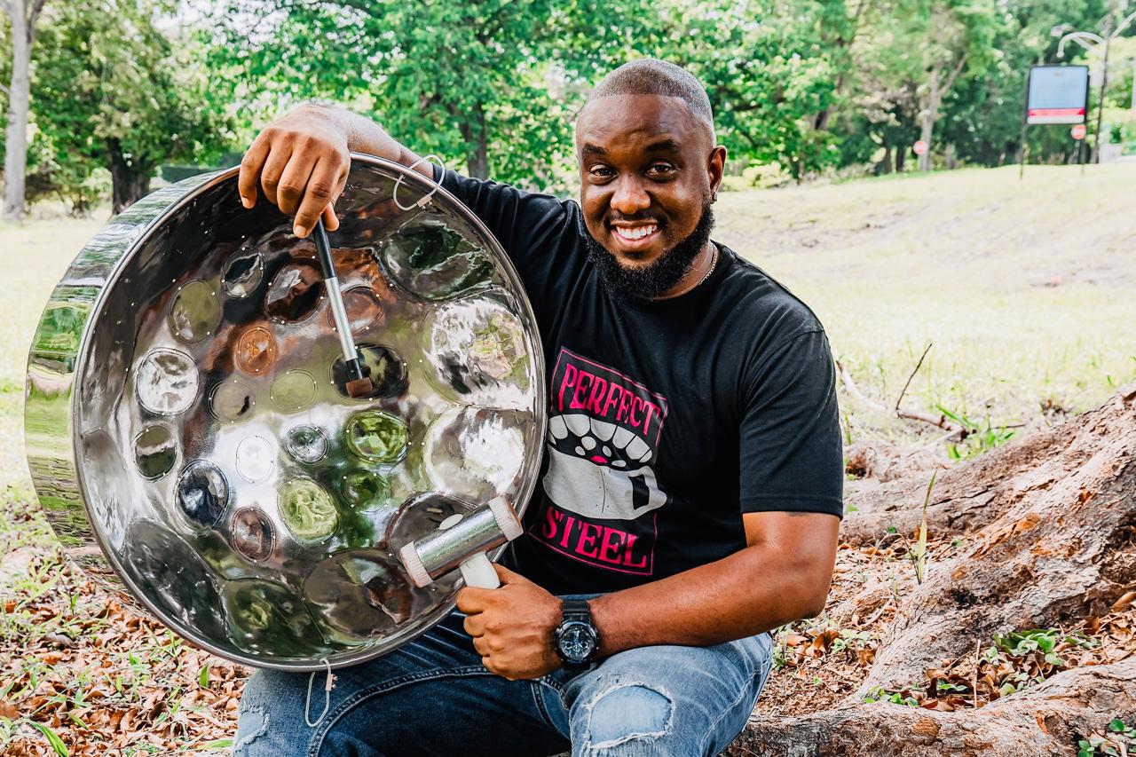 Juma Simmons holding a polished Perfect Steel steelpan